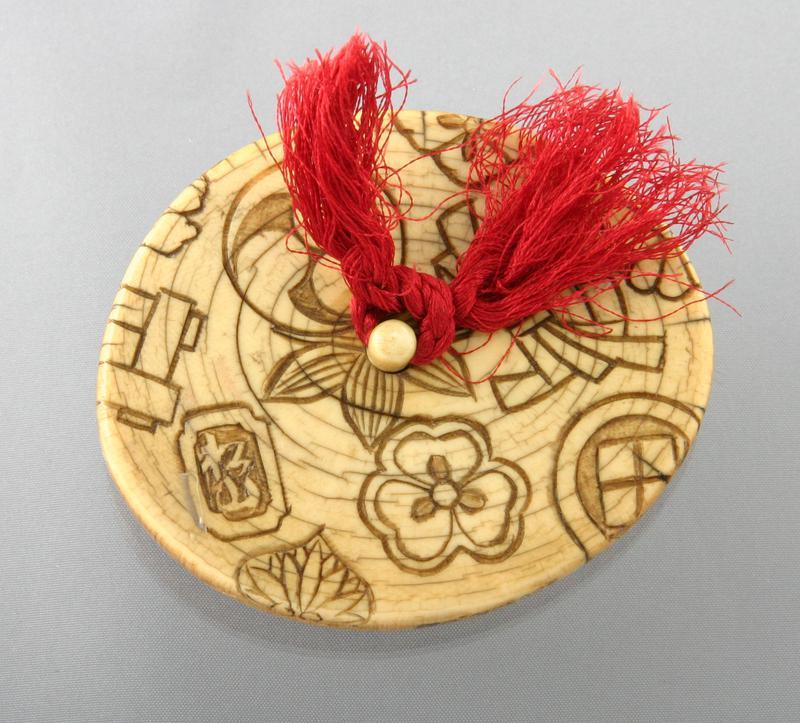 Netsuke with Chrysanthemums and Family Crests